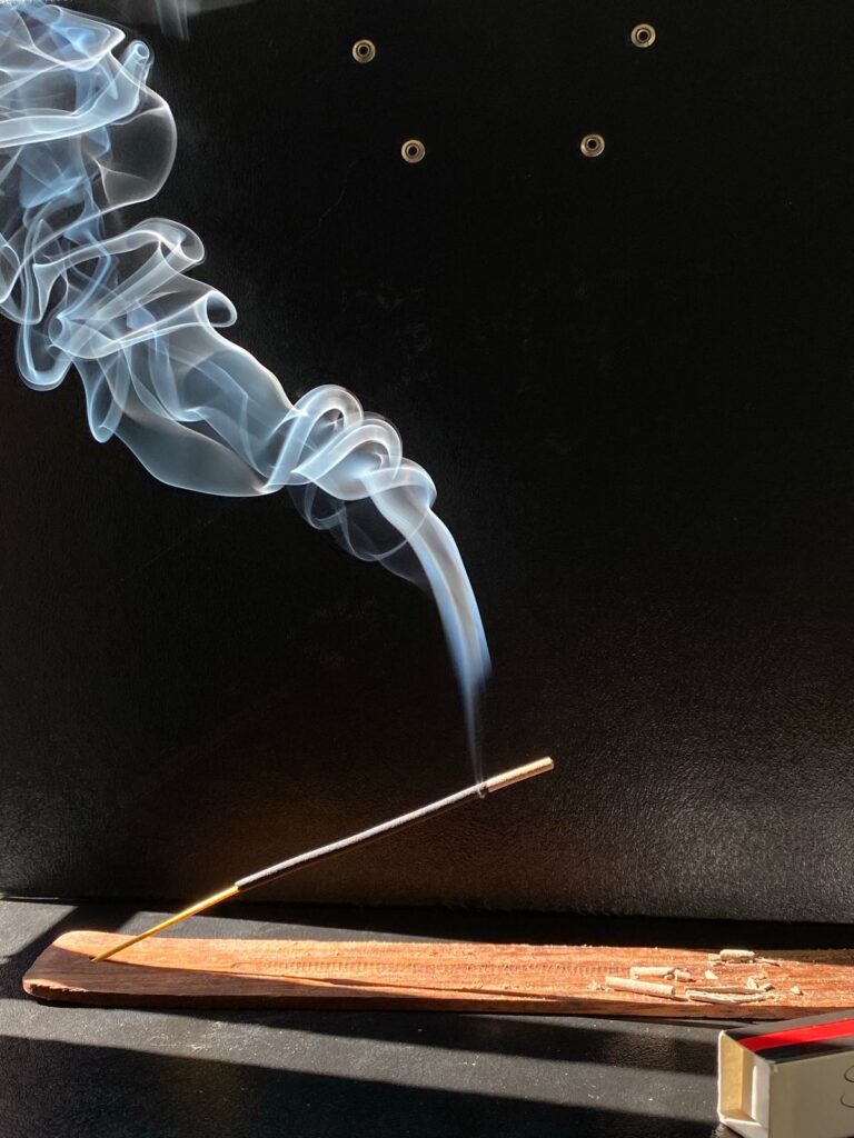 Burning incense stick with white smoke product photo
