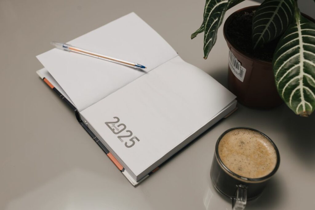 Minimalist desk setup with journal and coffee product photo